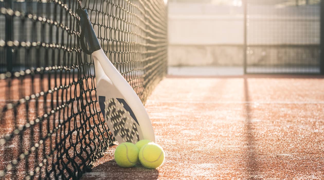 Two pairs playing padel on an indoor court